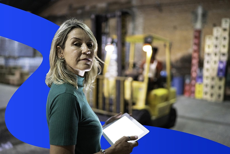 Woman standing in front of construction vehicles